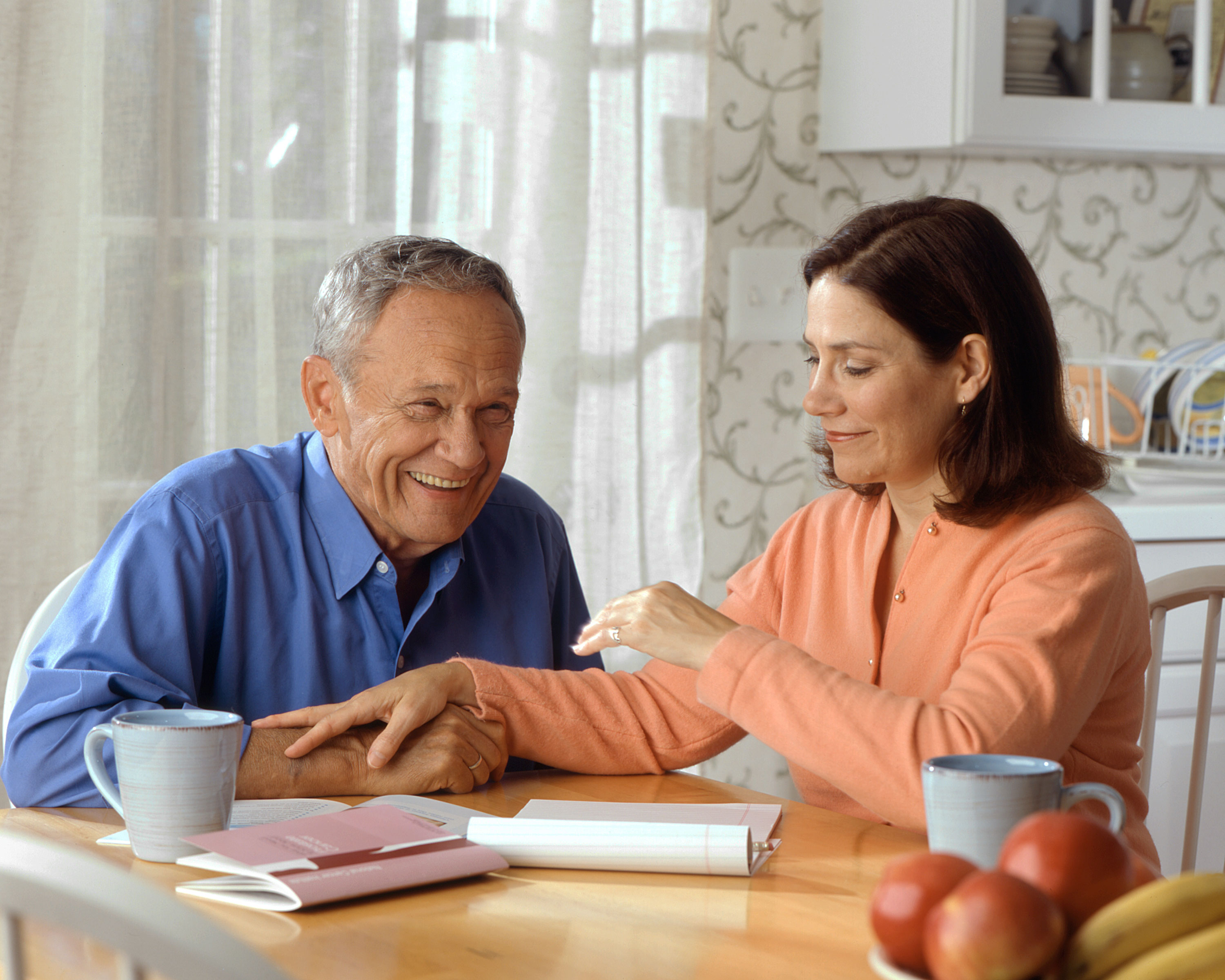 woman helping senior citizen