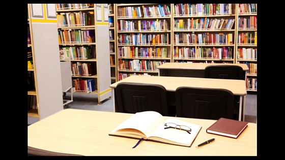 library desk with glasses