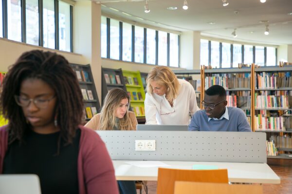 People at desks in a library