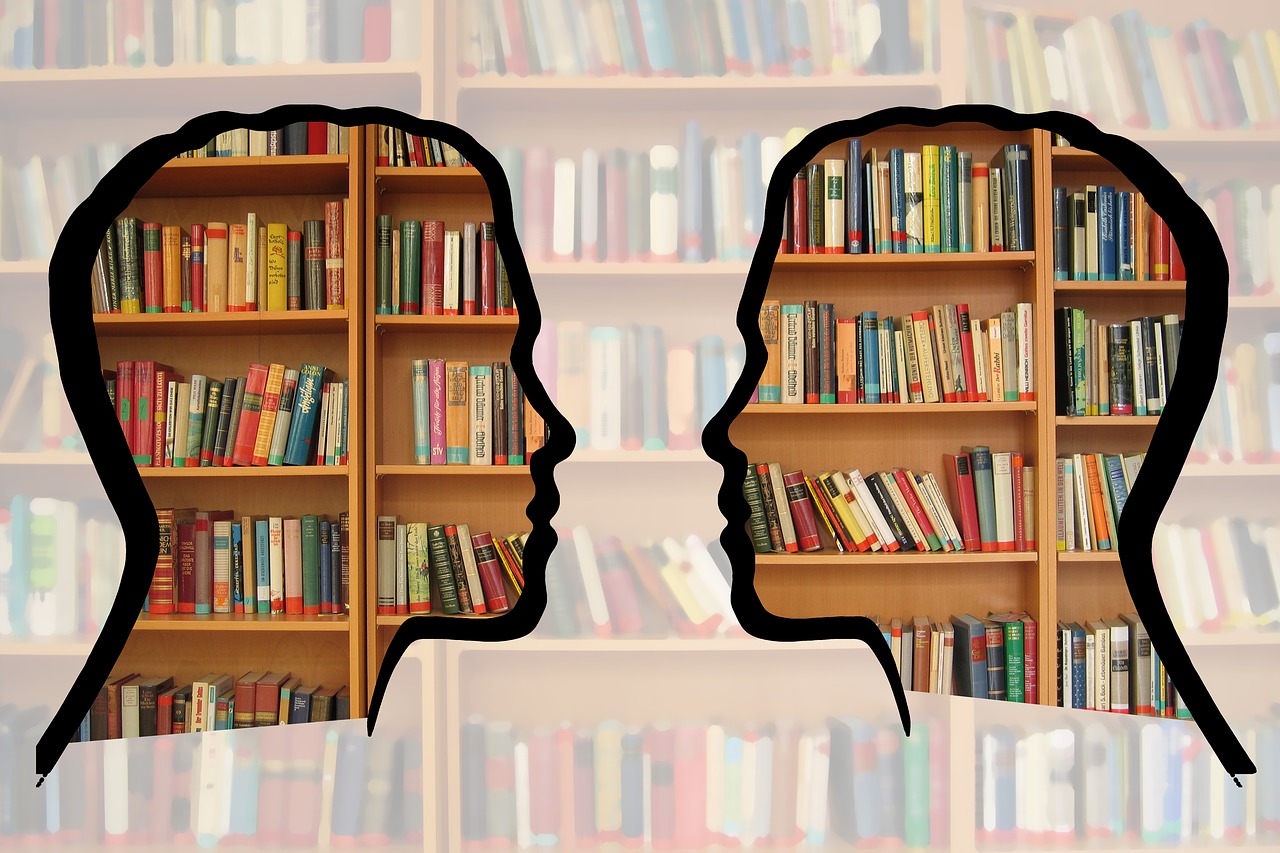 Silhouettes with books behind them