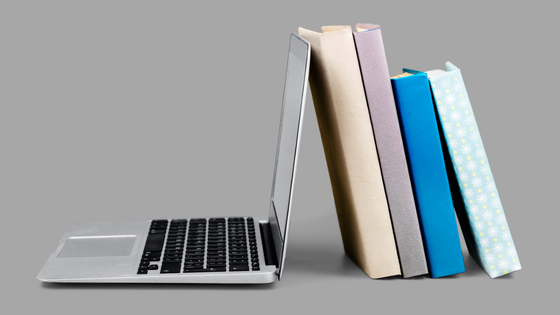 a laptop and a stack of books