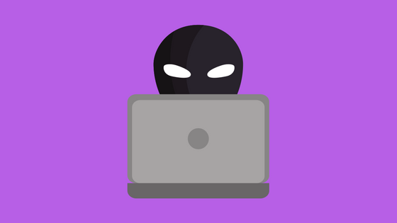 Masked face behind laptop