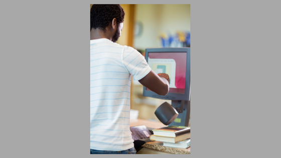 Man checking out books in library