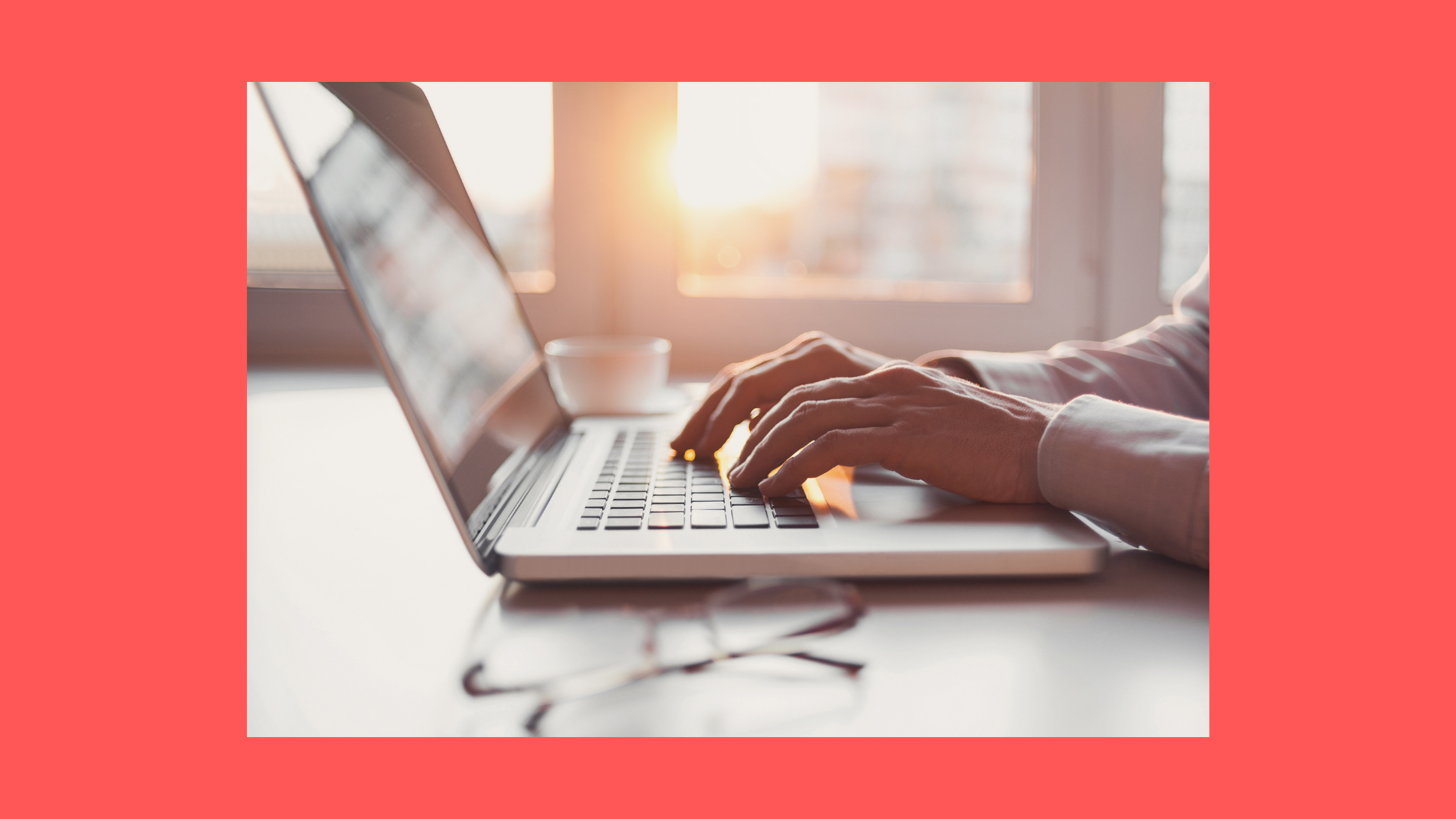 photograph of hands typing on a laptop keyboard